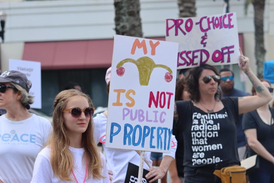 Protestors hold signs during “The People’s Abortion Rally” for abortion rights in front of the Duval County Courthouse