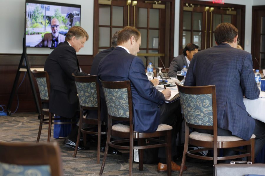 University of North Florida Board of Trustees members take notes as they listen to a presidential candidate during an interview