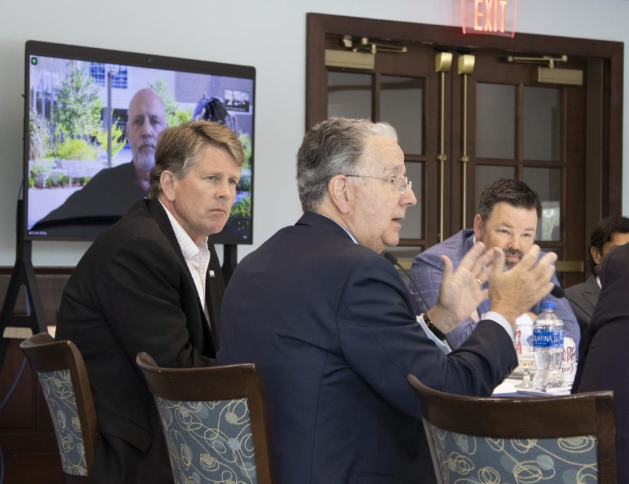 University of North Florida Board of Trustees Vice Chair Paul McElroy (center) talks during discussion while Trustees Tom Bryan (left) and John Gol (right)