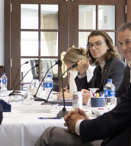 University of North Florida Board of Trustees member Nathaniel Rodefer listens to Chairman Kevin Hyde during the final day of presidential candidate interviews