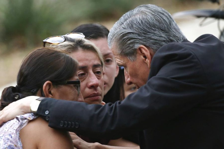 The archbishop of San Antonio, Gustavo Garcia-Siller, comforts families outside the Civic Center following a deadly school shooting at Robb Elementary School