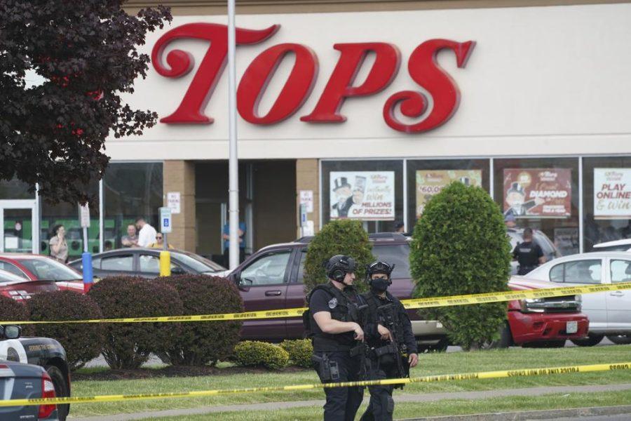 Police secure an area around a supermarket where several people were killed in a shooting