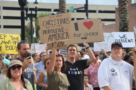 Protesters hold up signs during a rally for abortion rights