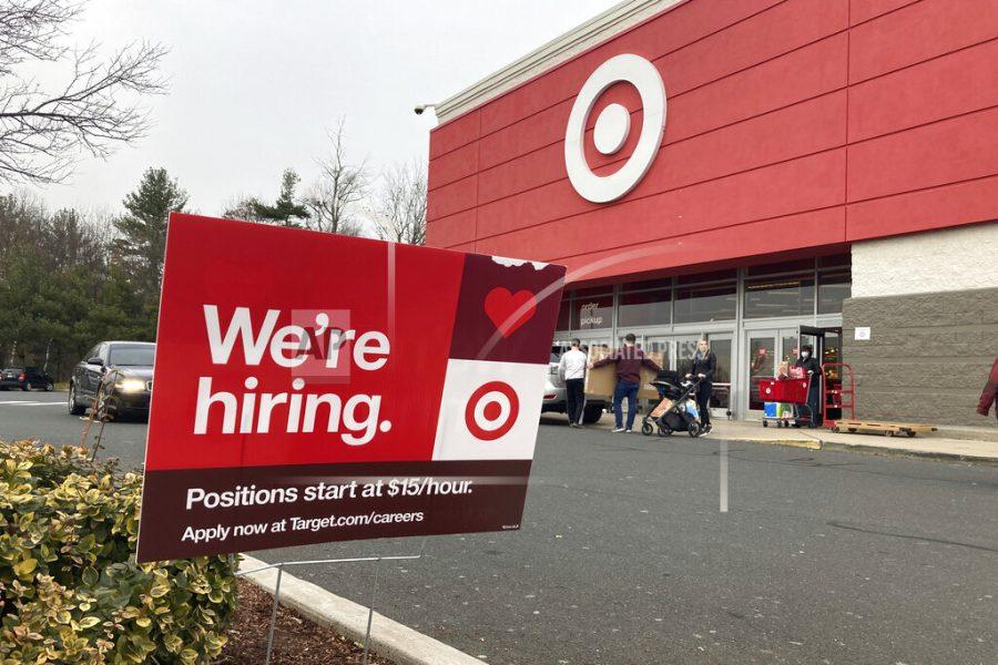 A hiring sign is in front of a Target store in Manchester, Conn., Nov. 39, 2021. Workers at Target stores and distribution centers in places like New York, where competition for finding and hiring staff is the fiercest, could see starting wages as high as $24 an hour this year. The Minneapolis-based discount retailer said Monday, Feb. 28, 2022 that it will adopt minimum wages that range from $15 to $24 an hour, with the highest pay going to hires in the most competitive markets. It currently pays a universal starting wage of $15 an hour. (AP Photo/Ted Shaffrey)