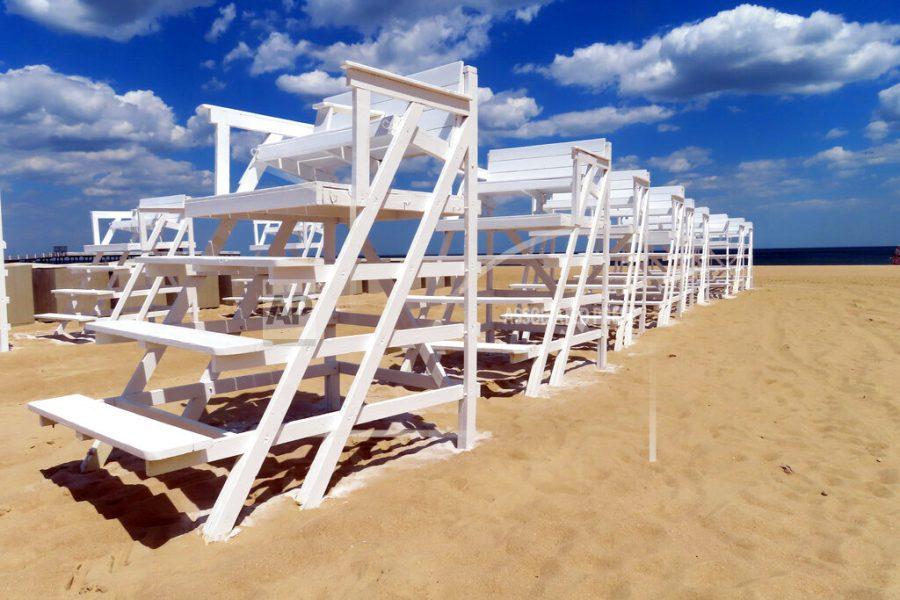 Rows of freshly painted lifeguard chairs dry in the sun in Belmar N.J., on Tuesday, May 17, 2022. 
