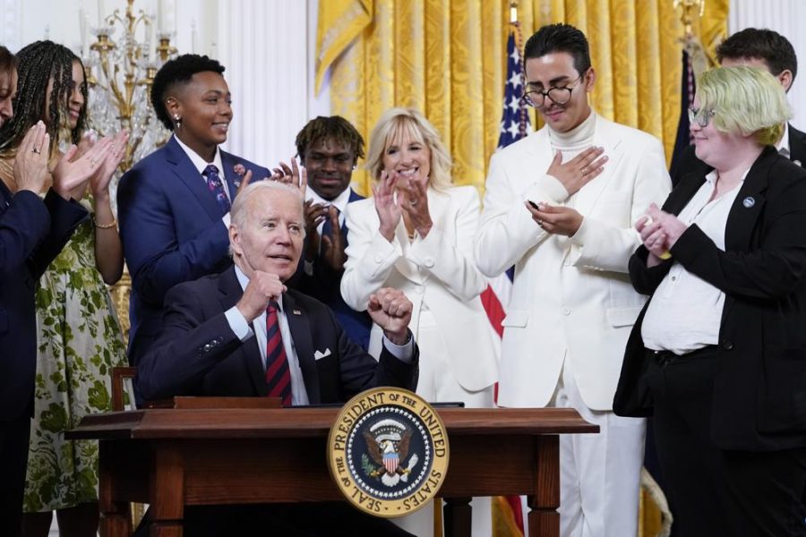 President Joe Biden celebrates after signing an executive order at an event to celebrate Pride Month