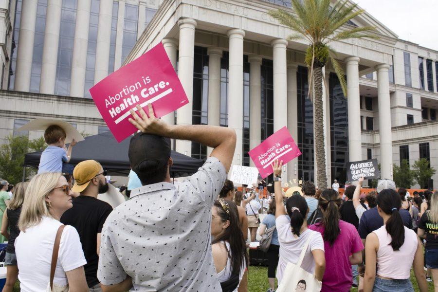 Abortion rights protesters hold up signs