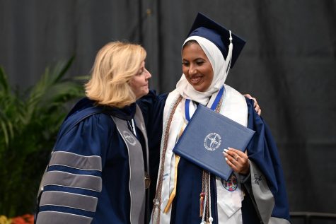 Chally congratulates a student at graduation