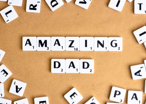 black and white tiles spell out AMAZING DAD on a table