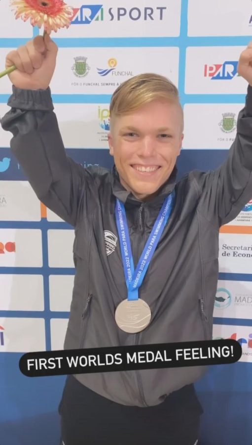 Morgan Ray raises his fists in the air in victory, smiling with a silver medal around his neck. text reads: first worlds medal feeling!