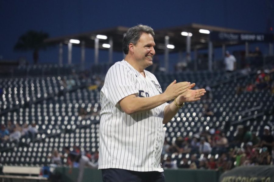 University of North Florida President Dr. Moez Limayem celebrates after throwing the first pitch at the Jacksonville Jumbo Shrimp game on Friday, August 19, 2022. 