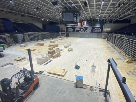 Construction equipment sit on the arena floor.