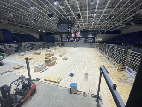 Construction equipment lays upon the floor of UNF Arena.