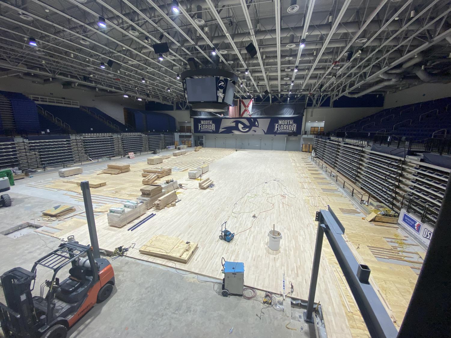 Construction equipment lays upon the floor of UNF Arena.