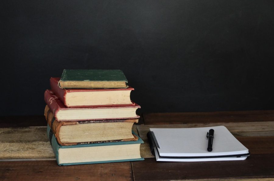 stack of books and an open notebook