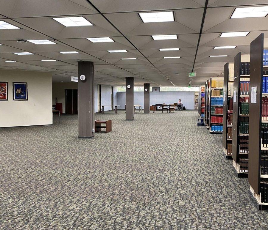 An open carpeted area next to bookshelves