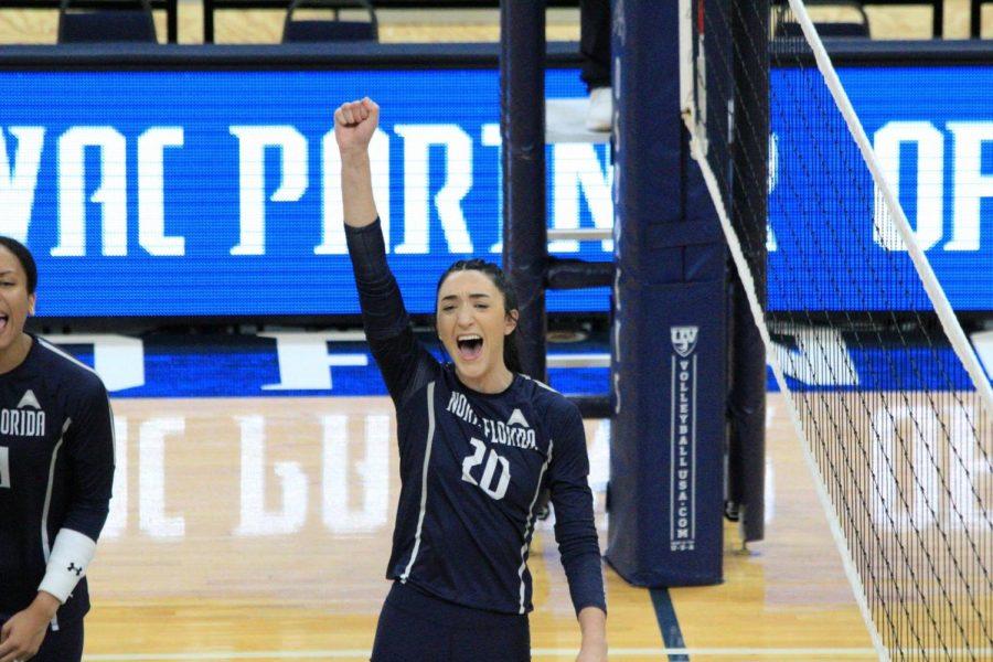 Volleyball player shouts with her hand in the air