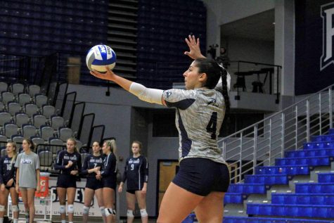 Volleyball player prepares to serve ball