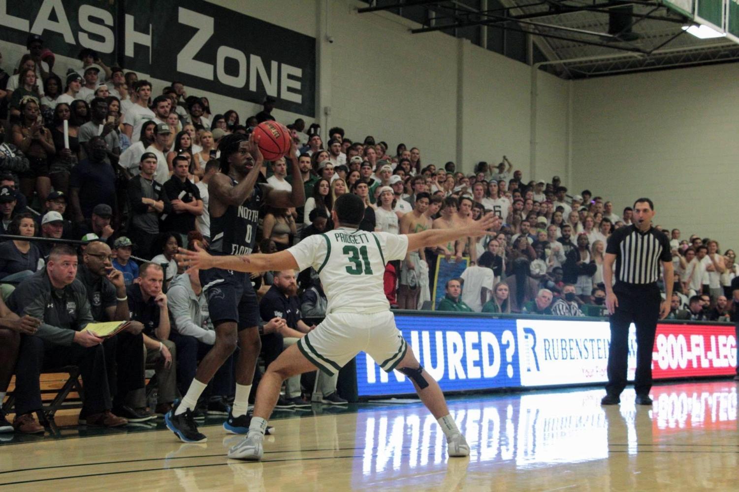 JU player defends shot from UNF player