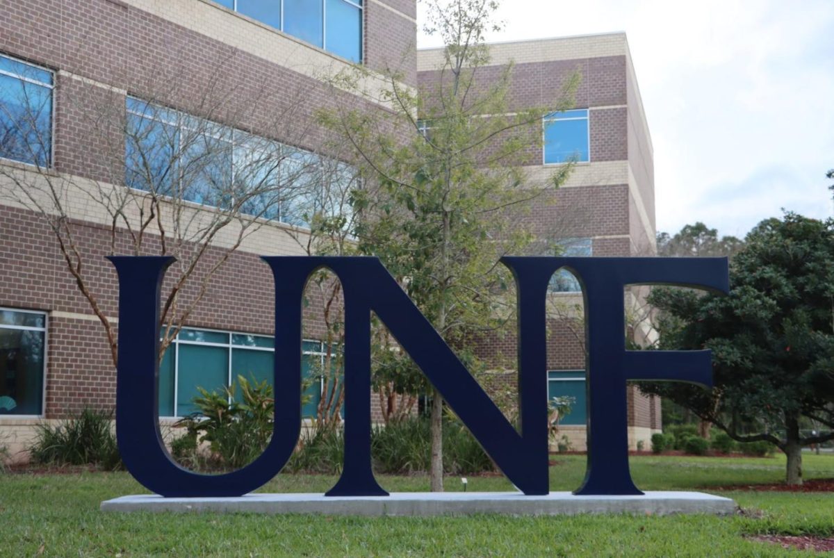 A large, blue statue with the letters UNF on a concrete slab