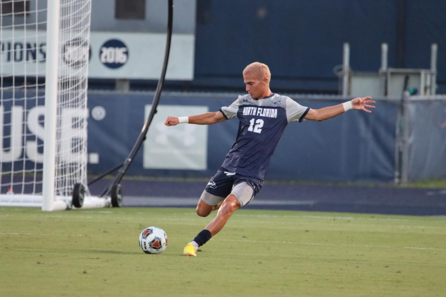 UNF soccer player prepares to kick the ball downfield.