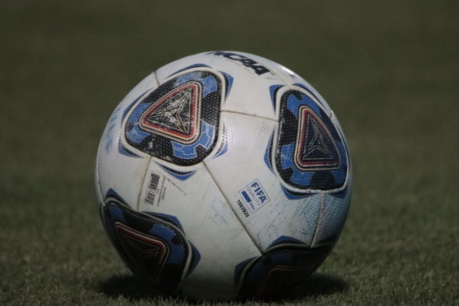 A soccer ball sits motionless on the field