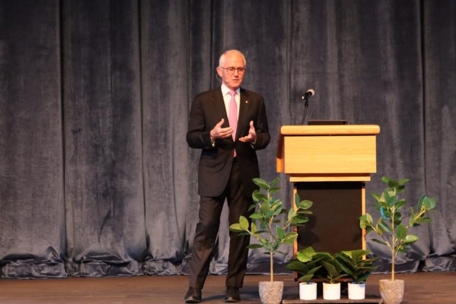 Malcolm Turnbull speaks next to a podium wearing a black suit