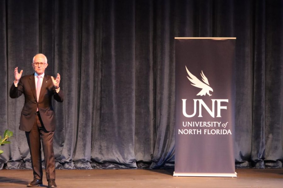 Malcolm Turnbull speaks on stage next to a UNF banner