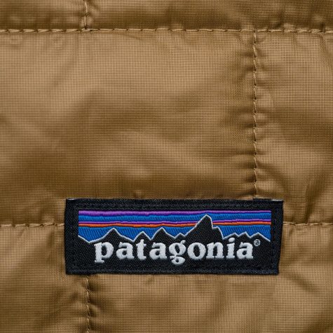 A brown fabric with the patagonia logo sown into it