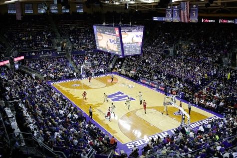 A full arena with a basketball court in the middle