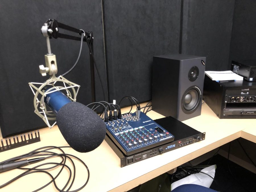 A microphone in a soundproof podcast studio