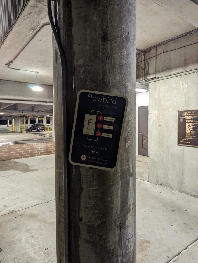 A tilted Flowbird sign by the parking garage