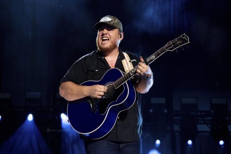 Luke Combs performing with his guitar