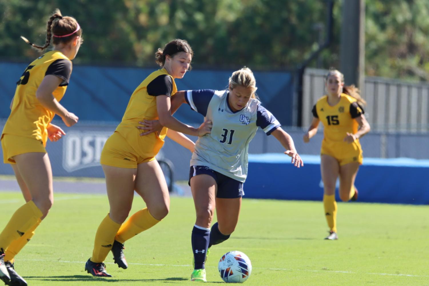 UNF player staves off defenders