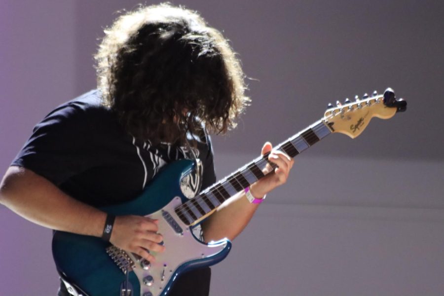 Member plays a guitar
