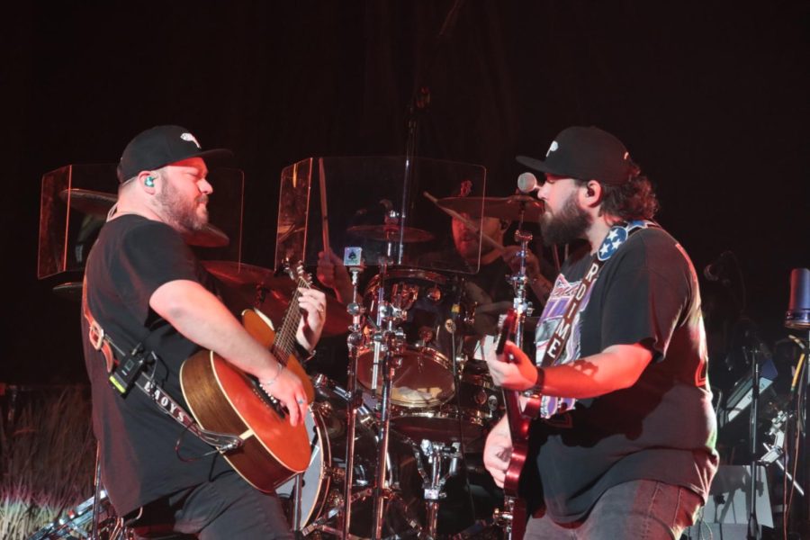 Mitchell Tenpenny performs with another guitarist
