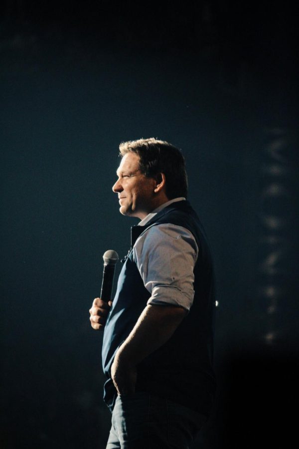 DeSantis holds a microphone on stage