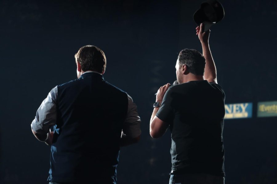 Luke Bryan stands next to DeSantis on stage