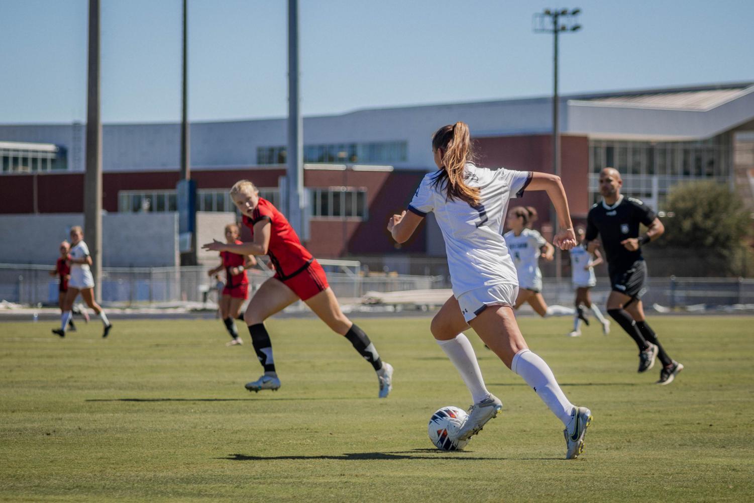 Soccer player works the ball downfield