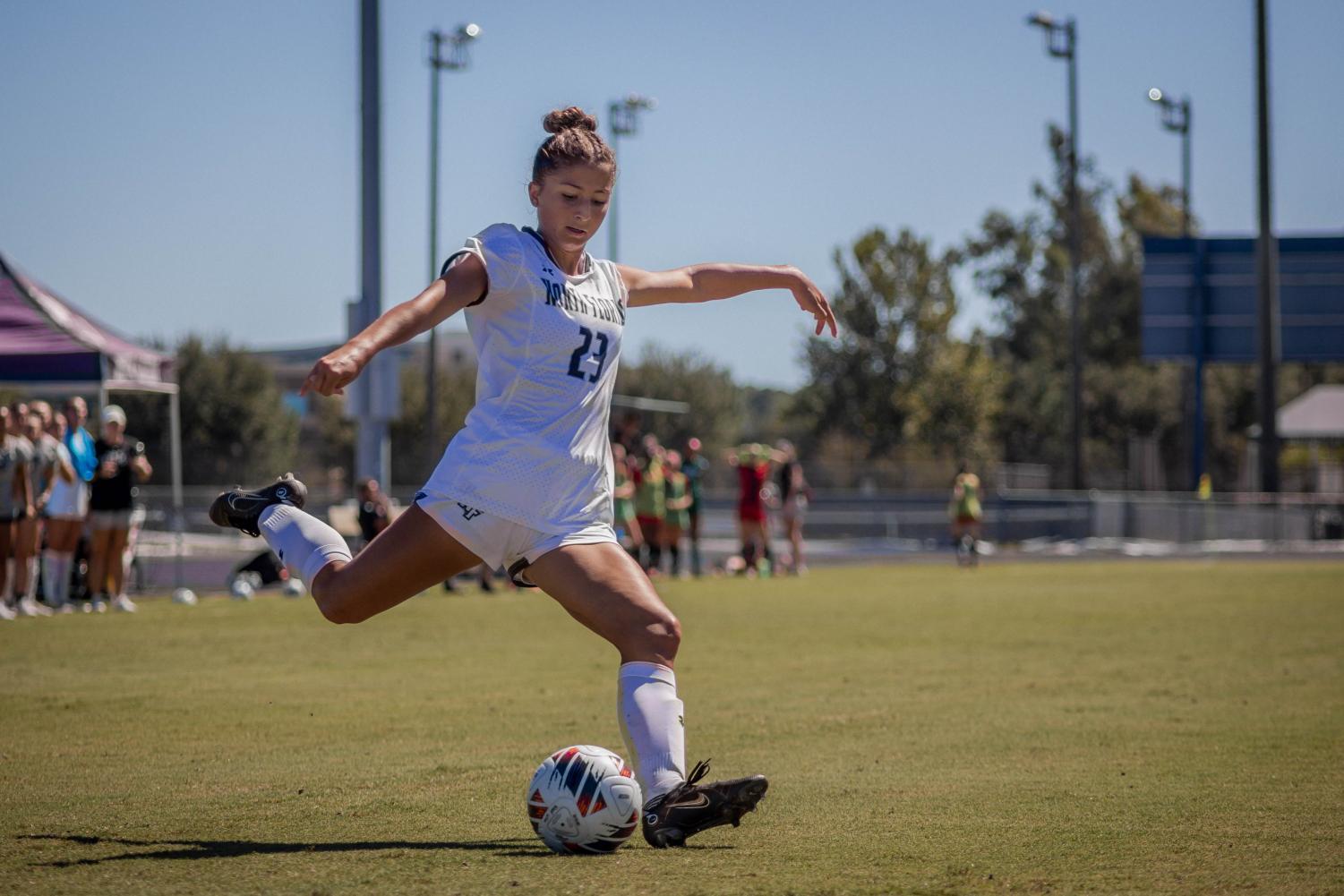 Midfielder winds up leg to kick the ball