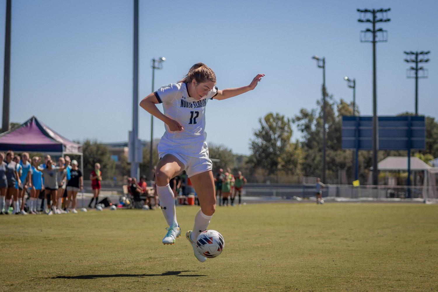 Soccer player prepares to kick the ball towards the net