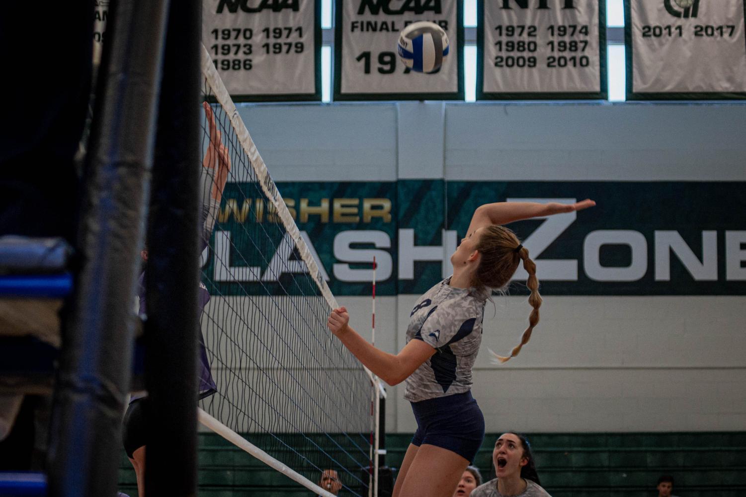 Volleyball player prepares to spike ball.