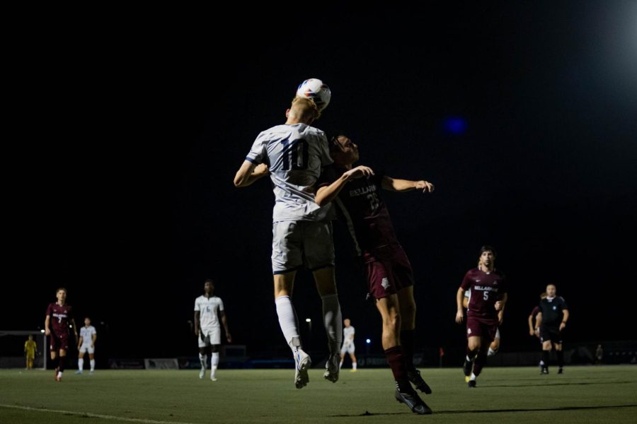 Two soccer players go for a contested header