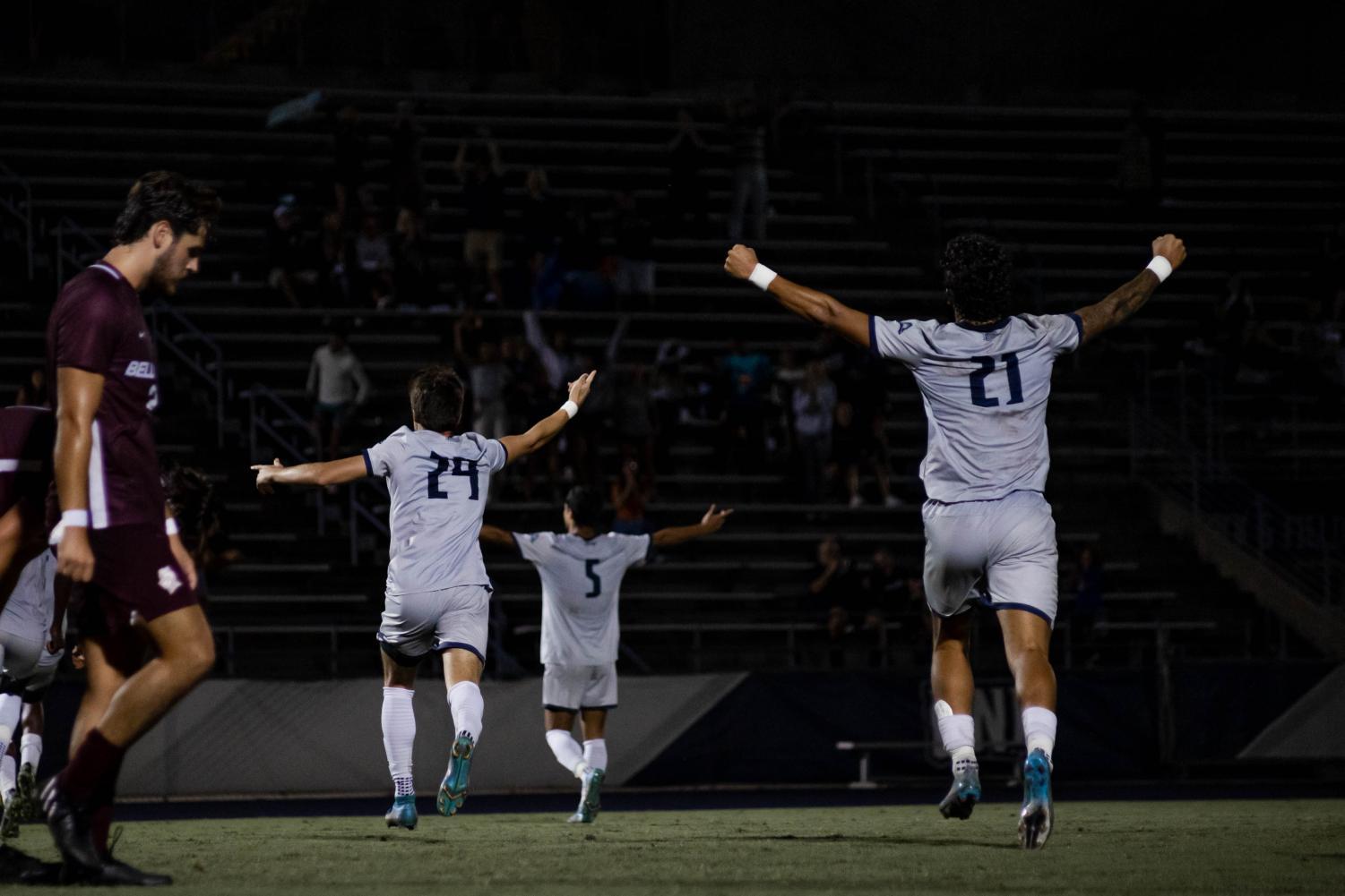 Soccer players celebrate a goal