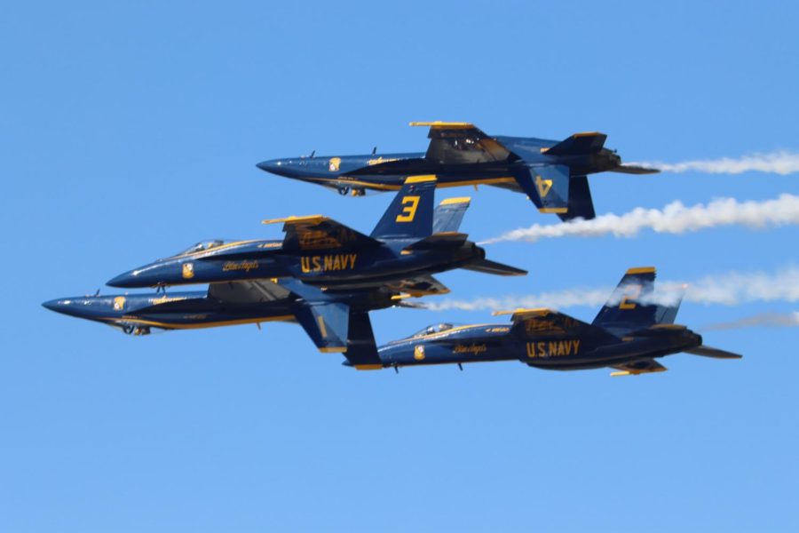 Four blue angels fly in formation
