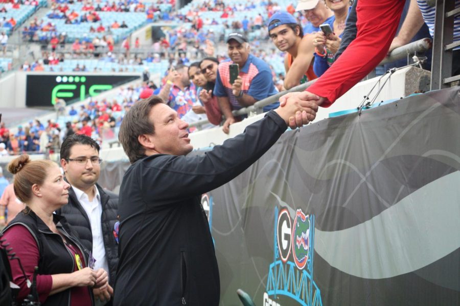 Florida Gov. Ron DeSantis shakes hands with fans at the Florida-Georgia game on Oct. 29. 