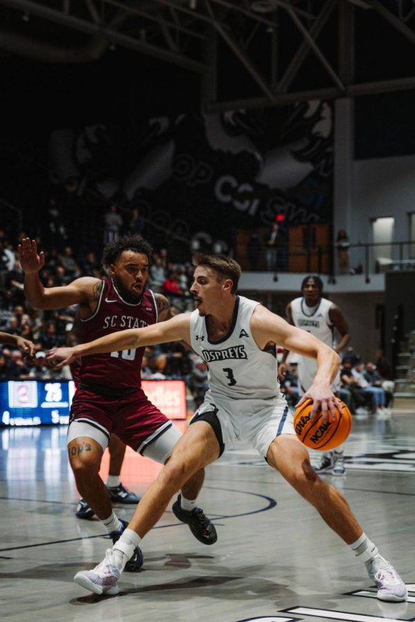 Basketball player dribbles into the paint