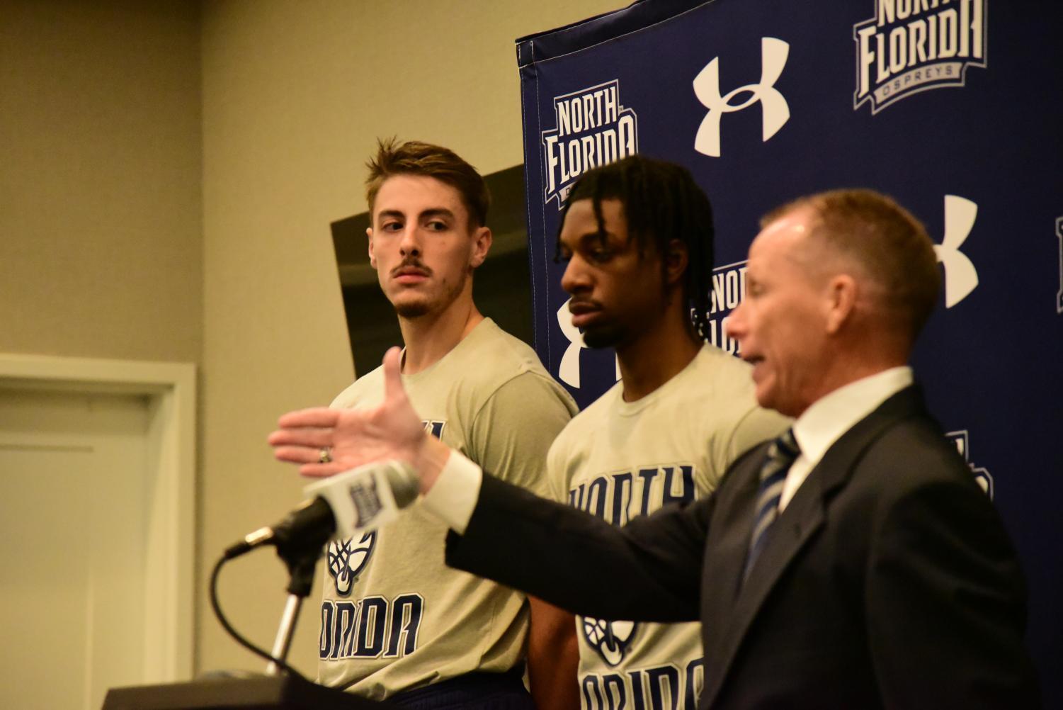 Hendricksen looks on as Coach Driscoll addresses the media