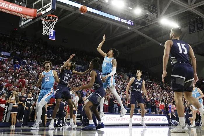 Opposing players battle for positioning near the rim.