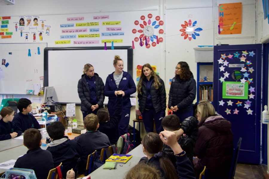 The UNF women's basketball players speak with young students